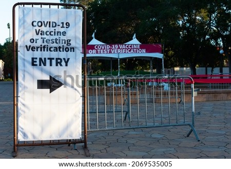Covid-19 Vaccine or Negative COVID-19 Testing Verification sign at the entrance to public event, concert or stadium