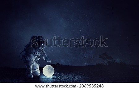 Astronaut and moon . Mixed media Royalty-Free Stock Photo #2069535248