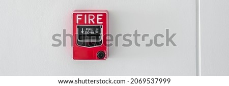 Panoramic image of fire alarm push button on building wall