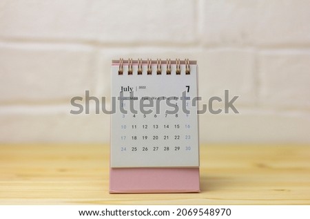 Turn over the calendar for July 2022. Desktop calendar for planning, organizing and managing each date
