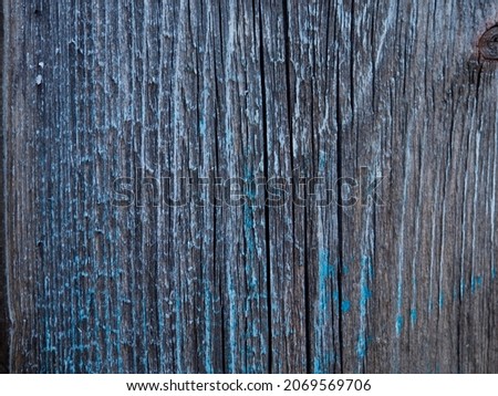 weathered dark wood background with texture. Texture of grey old wood with some blue. Wide burned board close-up. a wooden surface. Shot Of Wooden Planks. Copy space for your text