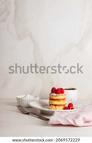 Breakfast- cheesecakes with raspberries and coffee