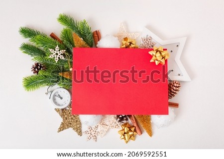 frame of Christmas tree branches and decorations with blank card and space for text white background. Top view. Xmas and New year concept. High quality photo