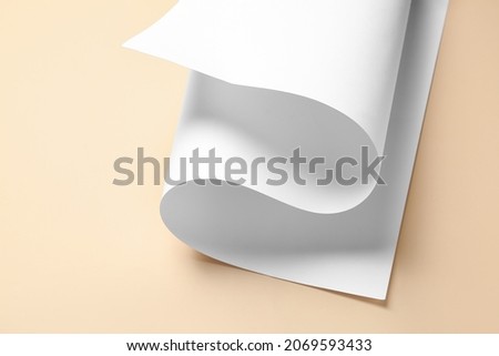 Rolled paper sheet on color background