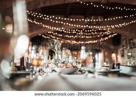 Beautiful wedding room with wedding table with food, flowers anddrinks, decorations,lights  Royalty-Free Stock Photo #2069596025