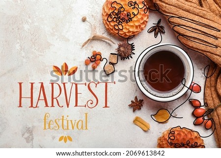 Beautiful autumn composition with cup of coffee and HARVEST FESTIVAL on light background