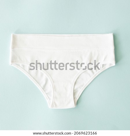 Natural cotton casual underwear white panties, classic model. Top view, flat lay. Natural underwear concept Royalty-Free Stock Photo #2069623166