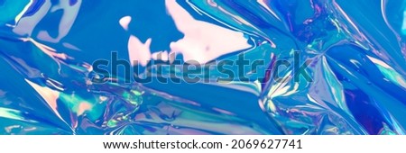 Blue blurred holographic banner. Crumpled foil material. Fluid textured background. 