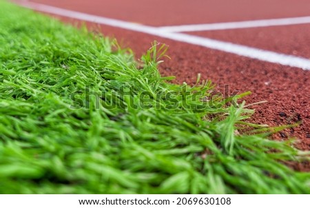 Green grass sports outdoor football field with running track in an athletics stadium. Turku, Finland.