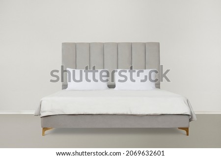 Modern gray bed with padded headboard Royalty-Free Stock Photo #2069632601