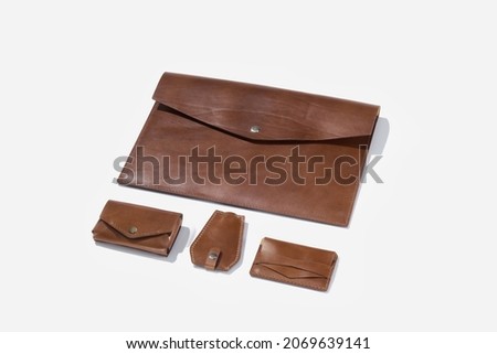 Leather men's business accessories from genuine leather handmade on a white isolated background. Fashionable and stylish accessories for a businessman