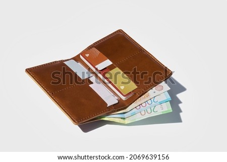 Genuine leather pormone for money documents and credit cards. White isolated background. A fashionable accessory for a business person