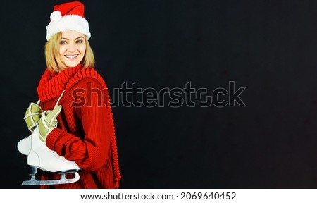 Smiling woman with ice skates. Ice skating girl. Winter sport activity. Leisure and vacation. Advertising.