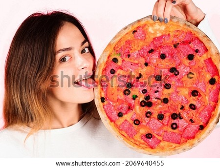 Smiling woman with italian pizza shows tongue. Fast food. Lunch. Food delivery. Pizza time.