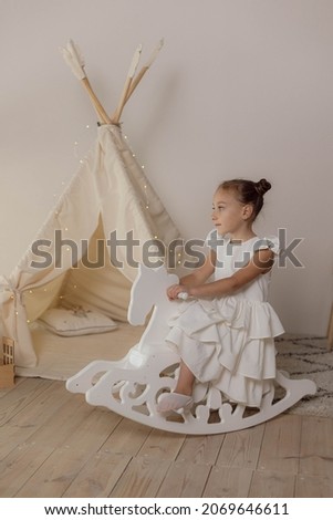 Minimalist studio photos with scandinavian decor of young girl wearing in basic clear white dress for creating mockup design and presentation fabric design
