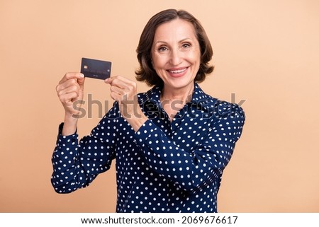 Photo of cool aged ceo brunette lady show card wear dotted blouse isolated on beige color background