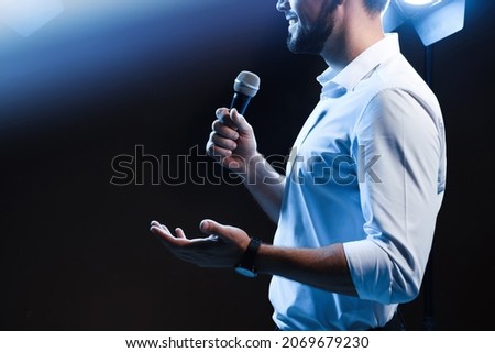 Motivational speaker with microphone performing on stage, closeup. Space for text Royalty-Free Stock Photo #2069679230