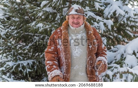 Lifestyle of older man on retired, senior man at winter snowy day at nature, recreation concept