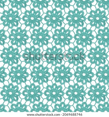 Seamless Irish lace pattern. Crochet. Blue yarn. Knitted snowflakes on a mesh of air loops. Lace on a white background. Royalty-Free Stock Photo #2069688746