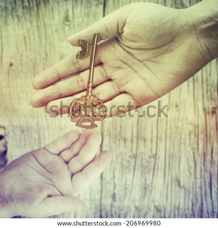Hand holding an old rusty key