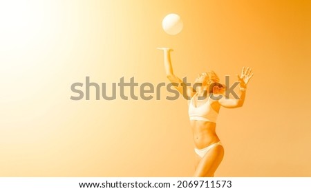 Young girl playing volleyball on the beach.Yellow color filter. Professional sport concept. Horizontal sport poster, greeting cards, headers, website and app