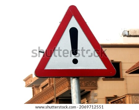  Red exclamation attention sign, danger red triangle road sign next to the road to make drivers alert and careful of upcoming danger or a hazard on the road         