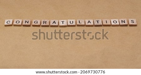Wooden letters tiles spelling CONGRATULATIONS