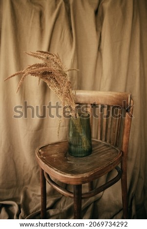 Ceramic brown jug with a bunch of ears of corn. Picture of a rural life.