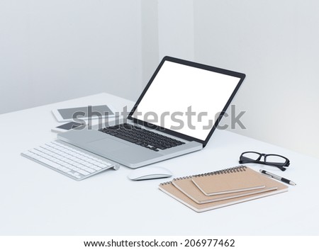blank screen laptop computer with notebook on the table