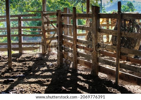 An old dirty and broken corral used to confine cows