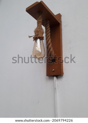 photo of a light bulb hanging on the wall of a house