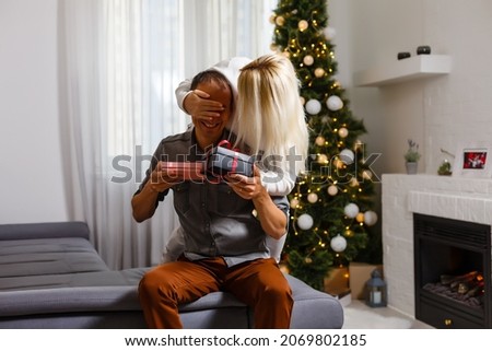Young happy couple near a Christmas tree