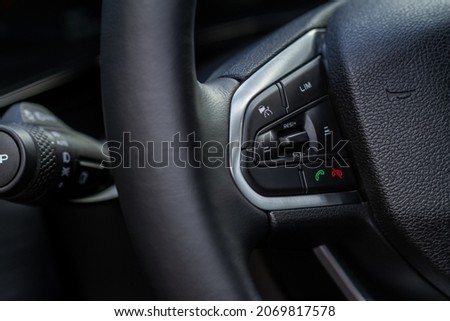 Cruise control switch closeup. Adaptive cruise control leaver. Cruise control on steering wheel. Royalty-Free Stock Photo #2069817578