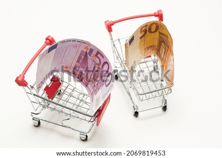 Shopping cart. Two trolleys - 50 (fifty) and 500 (five hundred) euro banknotes. Top view. Poor and rich life in Europe concept.