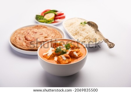 Paneer Butter Masala or Cheese Cottage Curry served with rice and laccha paratha Royalty-Free Stock Photo #2069835500