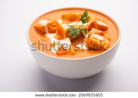 Paneer Butter Masala or Cheese Cottage Curry served with rice and laccha paratha Royalty-Free Stock Photo #2069835605