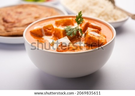 Paneer Butter Masala or Cheese Cottage Curry served with rice and laccha paratha Royalty-Free Stock Photo #2069835611