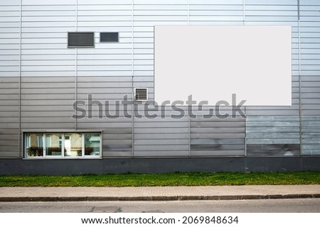 blank white billboard for advertisement on the facade of building, outdoor advertising mockup