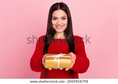 Photo of nice brunette lady hold present give you wear red pullover isolated on pink color background