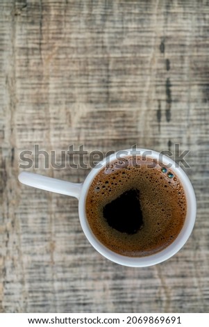 cup of coffee on the wooden table with copy space