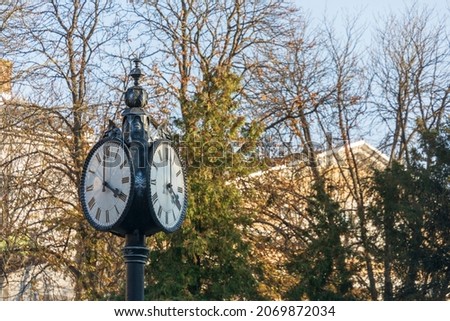 The dial of a street clock in the park in the city