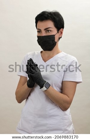Girl doctor in mask and gloves gesturing with her hands