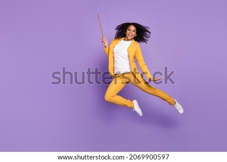 Photo of shiny sweet woman dressed yellow suit spectacles holding pointer empty space isolated violet color background