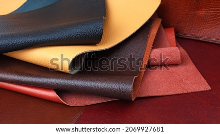 Different colors natural leather textures samples on brown leather background Royalty-Free Stock Photo #2069927681