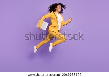 Photo of pretty charming woman dressed suit spectacles holding device jumping running isolated violet color background Royalty-Free Stock Photo #2069933129