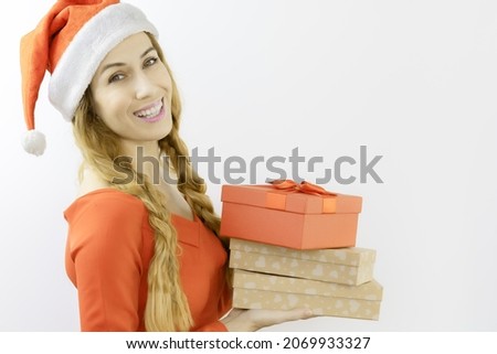 Happy lady Santa carries Christmas gifts. Joyful Christmas poster. New Year's photography. Festive mood