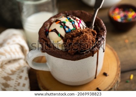 Chocolate mug cake with ice cream and festive sprinkles Royalty-Free Stock Photo #2069938823