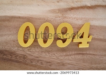 Golden Arabic numerals 0094 on a dark brown to white wood grain background.