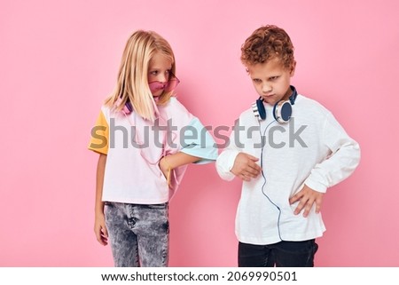 Portrait of a girl and a boy wearing headphones posing Childhood lifestyle concept