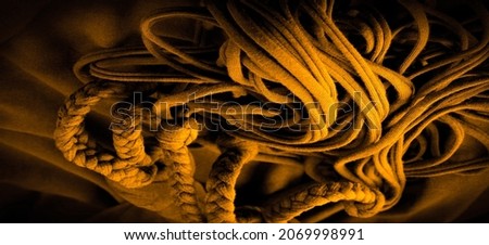 Texture, background, pattern. Fabric in yellow braids. Knitted knitted background with embossed pattern. Braids in knitting.